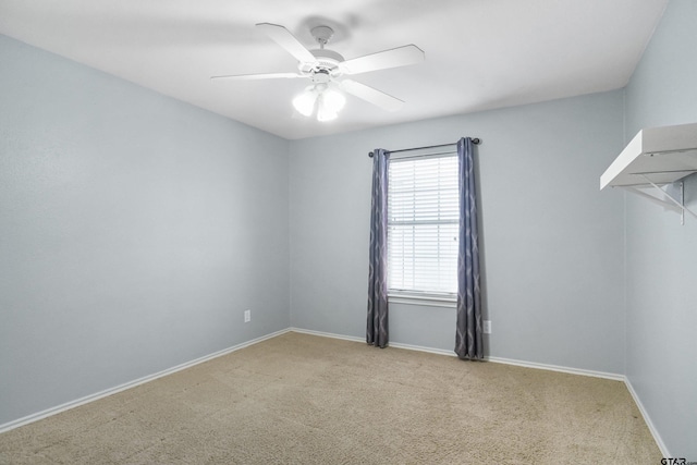 empty room featuring ceiling fan and light colored carpet