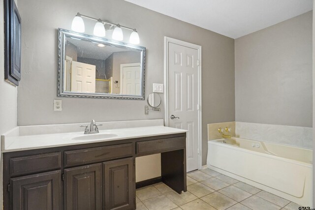 bathroom with vanity, tile patterned floors, and a tub