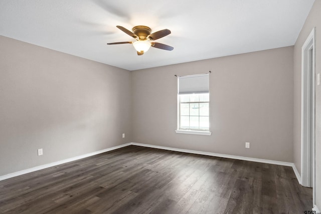 empty room with ceiling fan and dark hardwood / wood-style floors