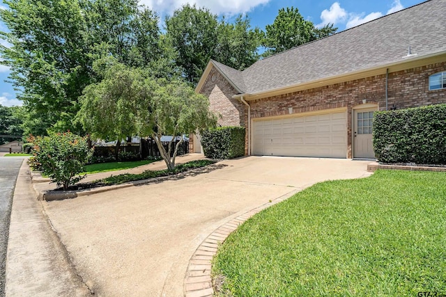 4831 Barclay Dr, Tyler, TX 75703 - view of front facade with roof with shingles, brick siding, concrete driveway, and a garage