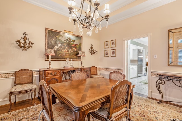 4831 Barclay Dr, Tyler, TX 75703 - dining room with a chandelier, ornamental molding, wainscoting, and wood finished floors