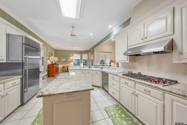 4831 Barclay Dr, Tyler, TX 75703 - kitchen with stainless steel appliances, under cabinet range hood, a center island, light tile patterned flooring, and ceiling fan