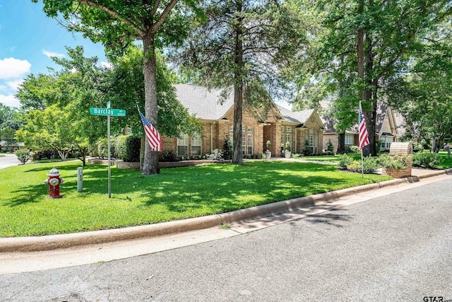 4831 Barclay Dr, Tyler, TX 75703 - view of front facade with a front yard and brick siding