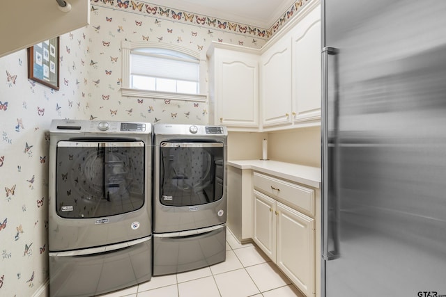 4831 Barclay Dr, Tyler, TX 75703 - washroom featuring cabinet space, independent washer and dryer, wallpapered walls, and light tile patterned flooring