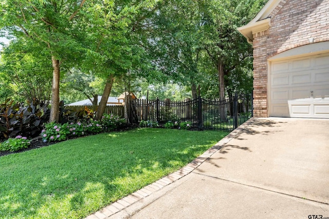 4831 Barclay Dr, Tyler, TX 75703 - view of yard with a garage and driveway