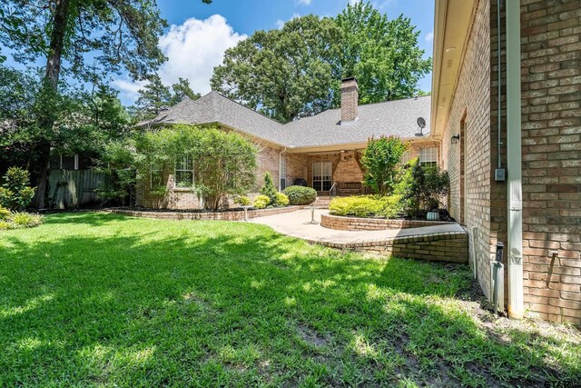 4831 Barclay Dr, Tyler, TX 75703 - rear view of house with brick siding, a shingled roof, and a chimney
