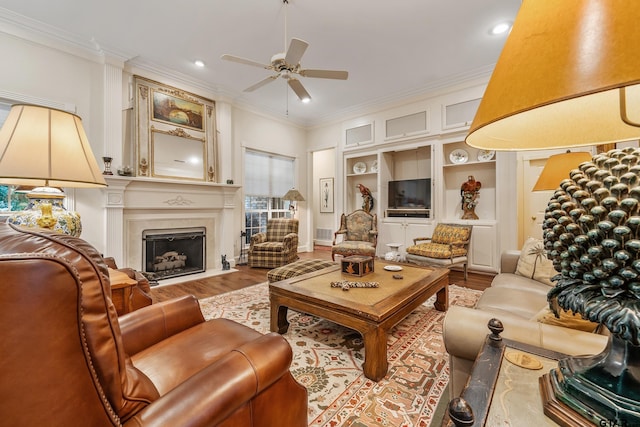 4831 Barclay Dr, Tyler, TX 75703 - living room with ornamental molding, wood finished floors, a ceiling fan, a premium fireplace, and recessed lighting