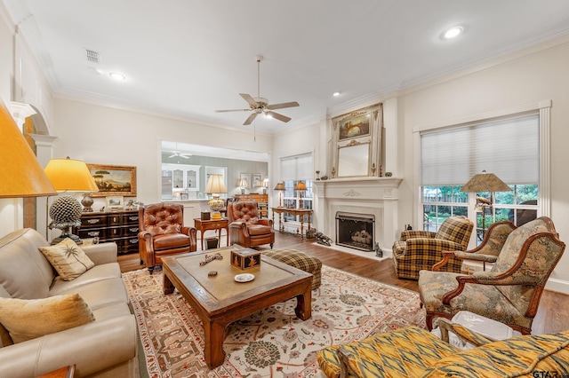 4831 Barclay Dr, Tyler, TX 75703 - living area with a fireplace, a ceiling fan, wood finished floors, ornamental molding, and recessed lighting