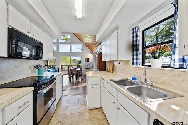 kitchen featuring white cabinets, a healthy amount of sunlight, and stainless steel electric range oven