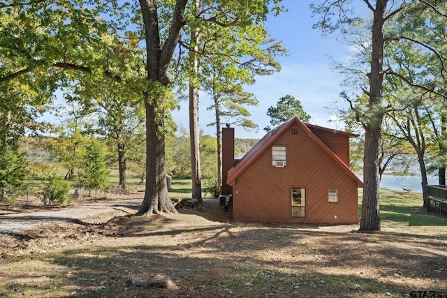 view of side of property featuring a water view and central AC