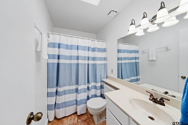 bathroom featuring vanity, tile patterned floors, toilet, a textured ceiling, and curtained shower