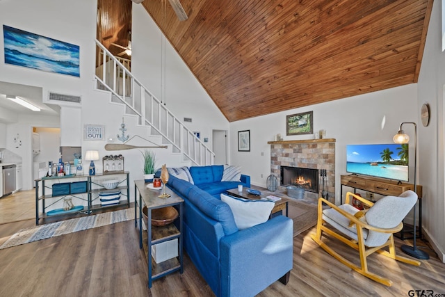 living room with hardwood / wood-style floors, ceiling fan, wooden ceiling, and high vaulted ceiling