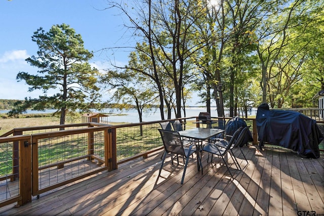 wooden deck featuring a water view and grilling area