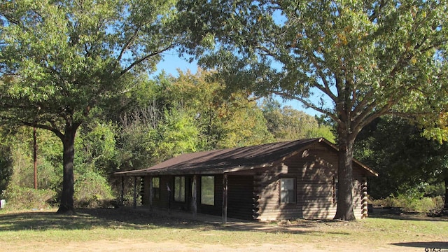 view of side of property with a yard