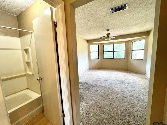 20624 Hewitt Cir, Chandler, TX 75758 - interior space featuring a textured ceiling, ceiling fan, and  shower combination