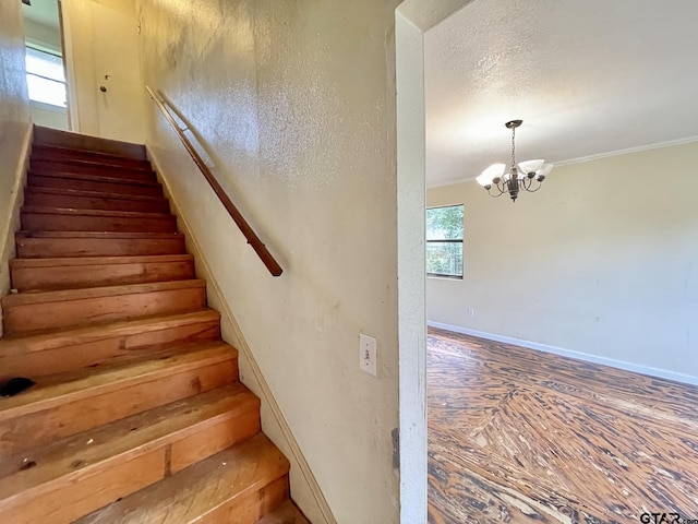 20624 Hewitt Cir, Chandler, TX 75758 - stairway featuring a chandelier, ornamental molding, and baseboards