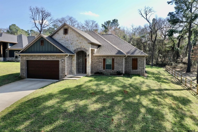 view of front of home with a garage and a front lawn