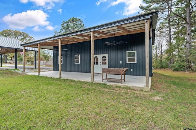 rear view of house featuring ceiling fan, a patio area, a yard, and french doors