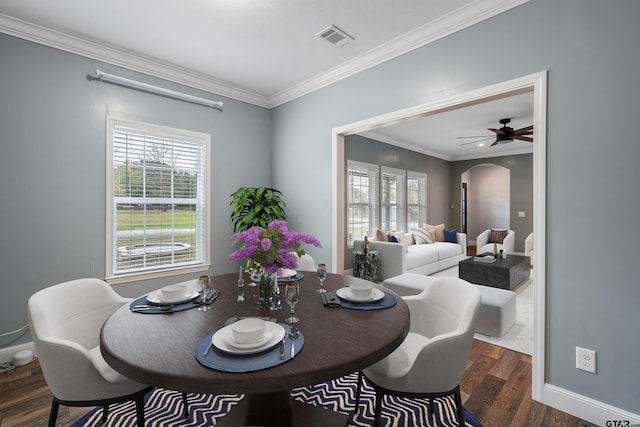 dining room with dark hardwood / wood-style floors, ceiling fan, and ornamental molding