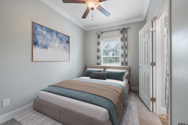 bedroom featuring light carpet, ceiling fan, and crown molding