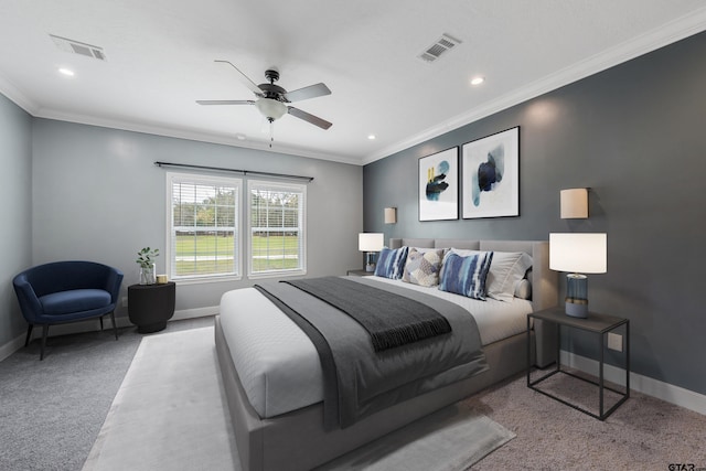 carpeted bedroom featuring ceiling fan and crown molding