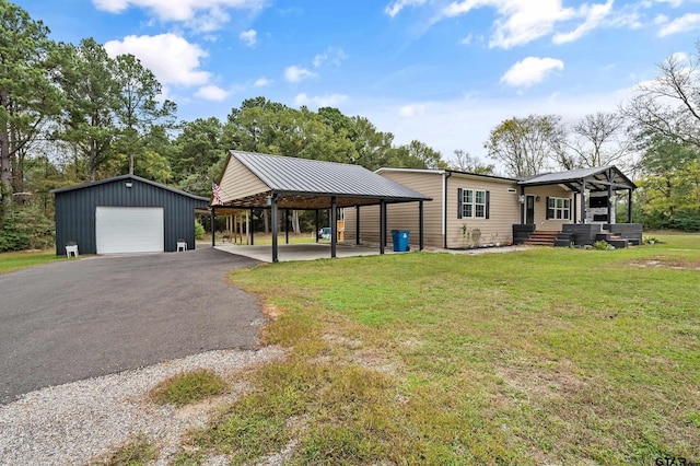 view of front facade with a front yard, a garage, a carport, and an outdoor structure