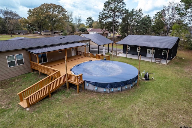 view of swimming pool with a lawn and a wooden deck