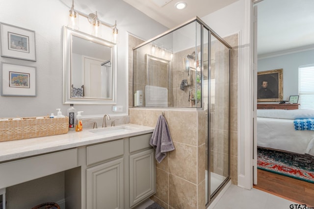 3363 Cascades Blvd, Tyler, TX 75709 - ensuite bathroom featuring ornamental molding, a shower stall, vanity, and tile patterned floors