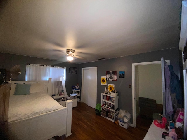 bedroom with dark wood-type flooring and ceiling fan