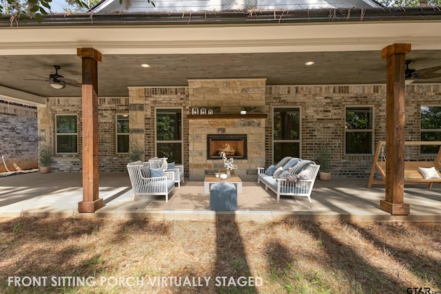 view of patio / terrace with ceiling fan and an outdoor stone fireplace