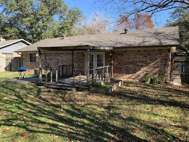 back of house featuring a yard, french doors, and a deck