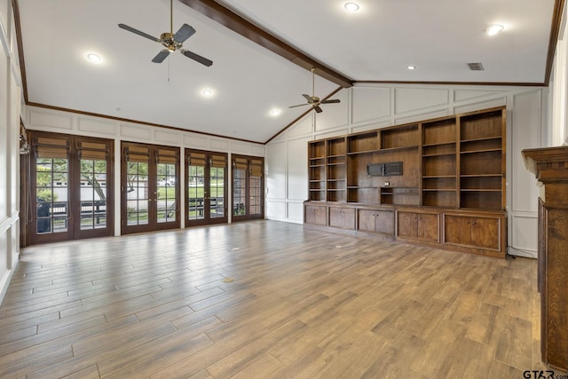 unfurnished living room featuring vaulted ceiling with beams, ceiling fan, light hardwood / wood-style flooring, and french doors