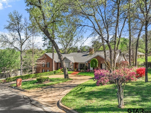 ranch-style home featuring a front yard