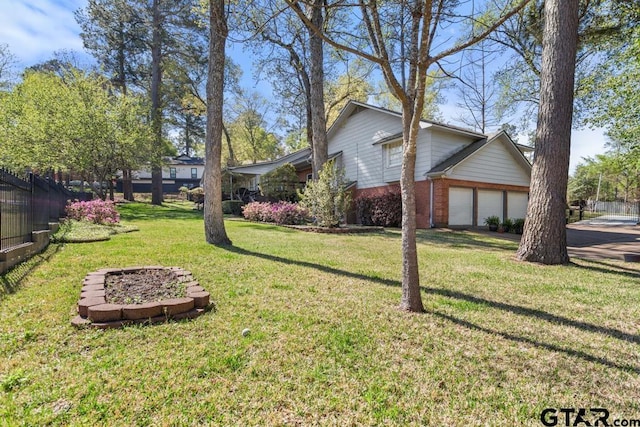 view of side of property with a lawn and a garage