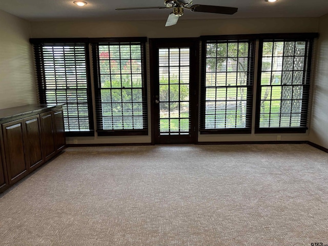 carpeted empty room with ceiling fan