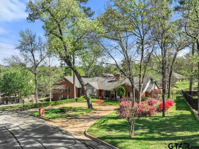 view of front of home with a front yard and a garage