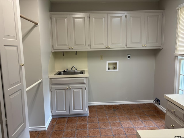 clothes washing area with cabinets, washer hookup, electric dryer hookup, and sink