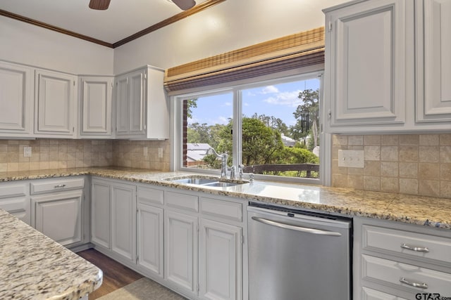 kitchen with dishwasher, backsplash, white cabinets, crown molding, and sink