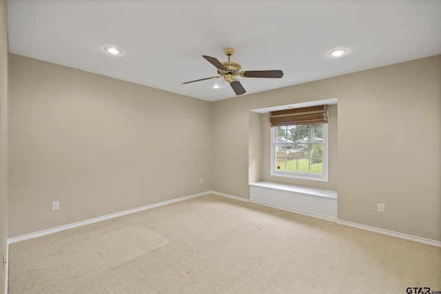 carpeted empty room featuring ceiling fan