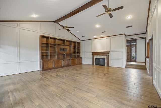 unfurnished living room featuring vaulted ceiling with beams, ceiling fan, a fireplace, and light wood-type flooring