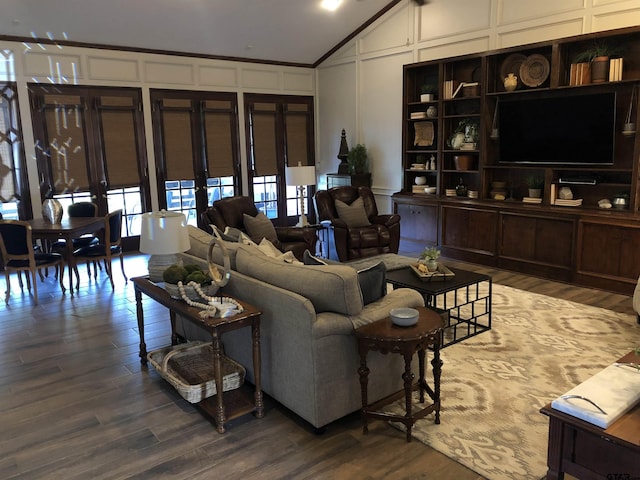 living room featuring lofted ceiling, dark hardwood / wood-style floors, and ornamental molding