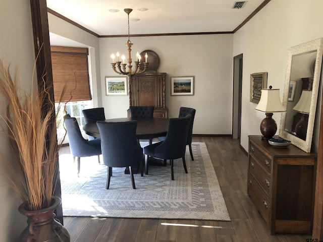 dining area featuring crown molding, dark wood-type flooring, and a chandelier