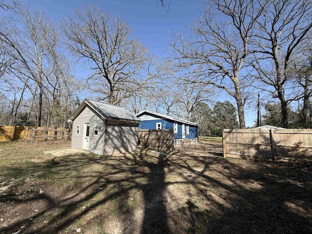 view of yard with an outdoor structure and fence private yard