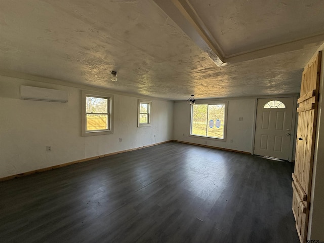empty room with dark wood-type flooring, a wall mounted AC, and baseboards