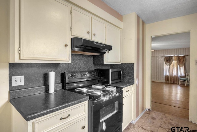 206 E Mims St, Tyler, TX 75702 - kitchen featuring stainless steel microwave, under cabinet range hood, decorative backsplash, black electric range oven, and dark countertops