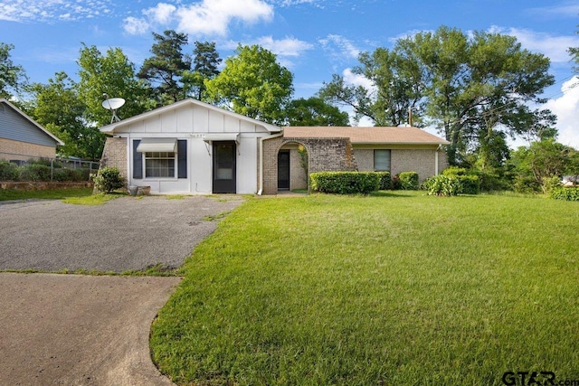 206 E Mims St, Tyler, TX 75702 - single story home with brick siding, board and batten siding, and a front lawn