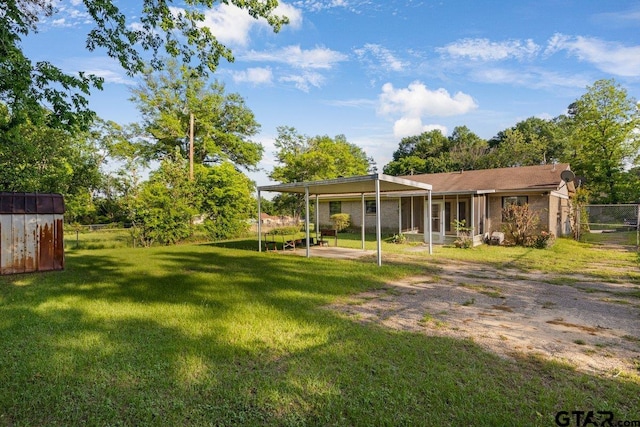 206 E Mims St, Tyler, TX 75702 - view of yard featuring a storage unit, fence, and an outbuilding
