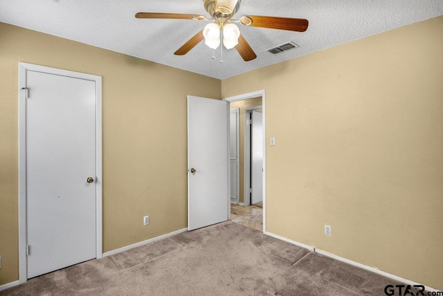 206 E Mims St, Tyler, TX 75702 - unfurnished bedroom featuring carpet floors, baseboards, visible vents, a ceiling fan, and a textured ceiling