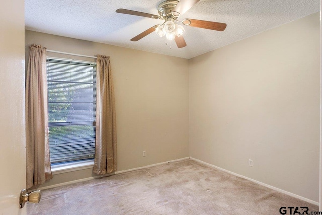 206 E Mims St, Tyler, TX 75702 - carpeted spare room featuring baseboards, ceiling fan, and a textured ceiling
