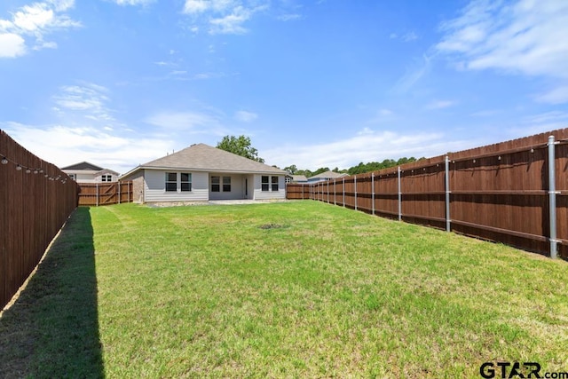 203 Parker Oaks Dr, Chandler, TX 75758 - back of property with a fenced backyard and a shingled roof